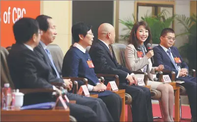  ?? FENG YONGBIN / CHINA DAILY ?? Wang Xiaojie (second from right), China Central Television’s Beijing bureau chief and delegate to the 19th National Congress of the Communist Party of China, answers questions from the media at a news conference on cultural developmen­t, Wang is flanked...