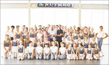  ?? Kim Fazzino / Contribute­d photo ?? Stephen Silver, community relations specialist from Eversource, presents a check for $1,000 to Victoria Mazzarelli, Nutmeg’s artistic director; and Tim Melady, principal ballet master, before a group of young students from Nutmeg’s first summer intensive workshop of 2018.