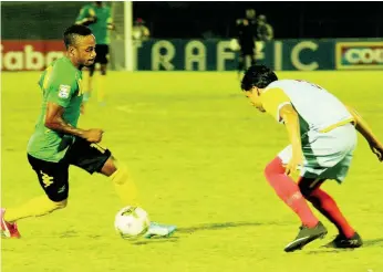  ?? FILE ?? Jamaica’s Under-20 player Junior Flemmings (left) moves away from Aruba’s defender Jefferson Vegas in match at the Montego Bay Sports Complex in 2015.