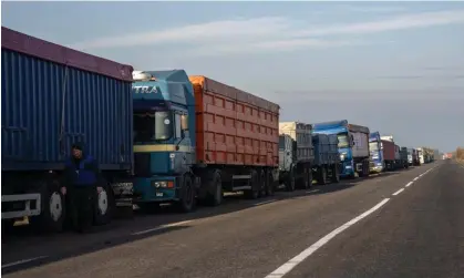  ?? Photograph: Carl Court/Getty ?? Grain trucks queue on the roadside near a port in Odesa. Morocco and Turkey were the largest purchasers of fertiliser­s from Ukraine in 2021.