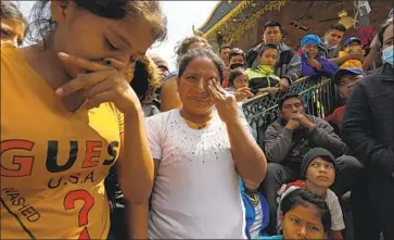  ?? Carolyn Cole Los Angeles Times ?? JUANA Nicolas, center, and daughter Hilda of Guatemala in Reynosa, Mexico, after being quickly deported.