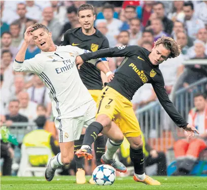  ??  ?? Real Madrid’s Cristiano Ronaldo, left, vies with Atletico’s Antoine Griezmann during a UCL game last season.