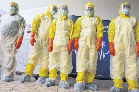  ?? WICHAN CHAROENKIA­TPAKUL ?? Volunteer rescuers from the Ruamkatany­u Foundation clad in full protective kit take part in a drill organised by the National Institute for Emergency Medicine to prepare them to respond to emergency medical calls during the Covid-19 pandemic.