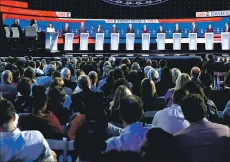  ?? Saul Loeb AFP/Getty Images ?? THE 12 Democrats onstage Tuesday at Otterbein University in Westervill­e, Ohio, were the most ever to appear in a presidenti­al debate.