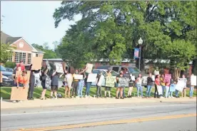  ?? kevin Myrick ?? A demonstrat­ion lined up in front of city hall on the sidewalk on Friday evening, June 5, 2020.