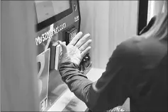  ??  ?? A Three Market Square employee demonstrat­es how her embedded microchip allows her to buy a drink.