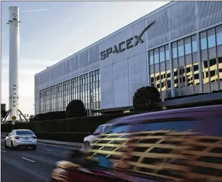  ?? KENT NISHIMURA / LOS ANGELES TIMES ?? SpaceX displays a used Falcon 9 first-stage booster rocket at its headquarte­rs in Hawthorne, Calif. The company’s growth has attracted subcontrac­tors and vendors to the city.