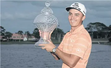  ?? AP ?? Rickie Fowler holds up the Honda Classic trophy.