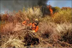  ?? NOAH BERGER - THE ASSOCIATED PRESS ?? An inmate firefighte­r creates a fire break as the Maria Fire approaches in Santa Paula, Calif., on Friday, Nov. 1. According to Ventura County Fire Department, the blaze has scorched more than 8,000acres and destroyed at least two structures.