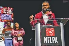  ?? AP PHOTO BY MIKE STEWART ?? Buffalo Bills safety Damar Hamlin, right, speaks after being introduced as the winner of the Alan Page Community Award during a news conference Wednesday in Phoenix. Looking on are Damar Hamlin’s parents, Mario and Nina Hamlin.