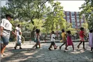  ?? BEBETO MATTHEWS — THE ASSOCIATED PRESS FILE ?? Children from a daycare are escorted Aug. 1, 2007in Marcus Garvey Park in the Harlem neighborho­od of New York.