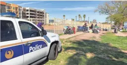  ??  ?? Phoenix police monitor a camp along Third Street.
