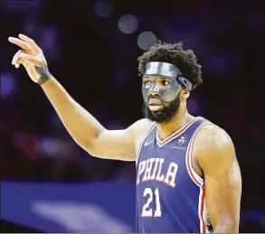  ?? Yong Kim / TNS ?? 76ers center Joel Embiid raises his fingers against the Miami Heat during Game 6 of the Eastern Conference playoffs on Thursday in Philadelph­ia.