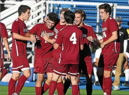  ?? PETE BANNAN — DIGITAL FIRST MEDIA ?? West Chester Henderson players embrace senior Frank DeRosa (second from left) after he scored against Conestoga in the District 1 Class AAAA Championsh­ip on Saturday.