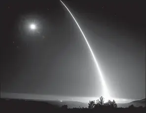 ?? Los Angeles Times/AL SEIB ?? A Minuteman missile launched from Vandenberg Air Force Base near Santa Barbara, Calif., leaves a fiery trail over a moonlit Pacific Ocean during a test flight in early May.