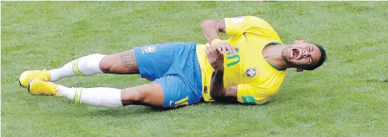  ??  ?? Brazilian superstar Neymar rolls on the pitch in apparent agony during Monday’s round-of-16 victory over Mexico. He somehow managed to continue.