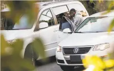  ?? Scott Strazzante / The Chronicle ?? A man — later identified by San Francisco police and a parole agent as Delon Terrance Barker — takes a bag through a broken window of a van parked on Lombard Street in January.