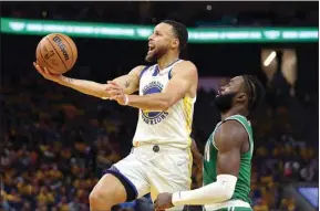  ?? JED JACOBSOHN / AP ?? Golden State Warriors guard Stephen Curry, top, shoots against Boston Celtics guard Jaylen Brown during Game 1 of the NBA Finals in San Francisco on Thursday.