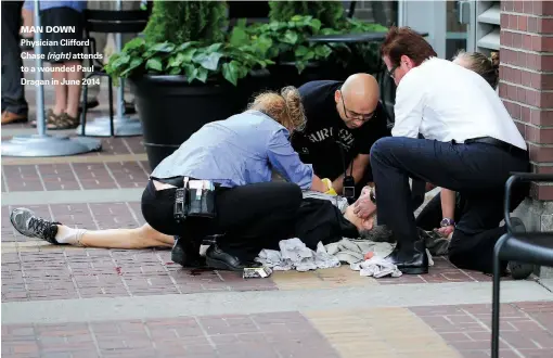  ??  ?? MAN DOWN Physician Clifford Chase (right) attends to a wounded Paul Dragan in June 2014