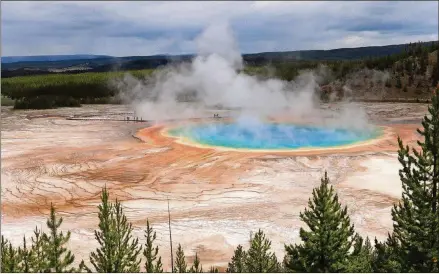  ?? ALEX PULASKI/FOR THE WASHINGTON POST ?? Steam rises off the surface of the Grand Prismatic Pool, one of Yellowston­e’s best-known sights.