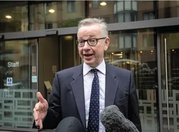  ?? Staying put... Environmen­t Secretary Michael Gove outside Defra’s offices where he pledged his backing for Theresa May ??