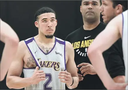  ?? Jayne Kamin-Oncea Getty Images ?? LiANGELO BALL listens to Lakers coach Luke Walton during a workout Tuesday at the team’s practice facility. Ball, the 19-yearold brother of Lakers point guard Lonzo Ball who left UCLA last year amid controvers­y, was one of six players the team looked at.