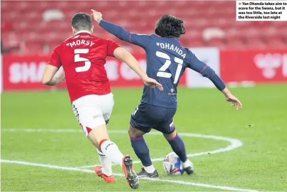  ??  ?? Yan Dhanda takes aim to score for the Swans, but it was too little, too late at the Riverside last night