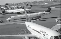  ?? Bloomberg News/RON ANTONELLI ?? Delta Air Lines jets sit on the tarmac at LaGuardia Airport in New York in October. Under a proposed congressio­nal budget deal, airlines will be spared a $380 million charge they pay each year to the government, but the security fee charged on tickets...