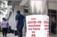  ?? (AFP) ?? A sign offering COVID-19 vaccinatio­ns is seen outside of a CVS pharmacy in Washington recently.