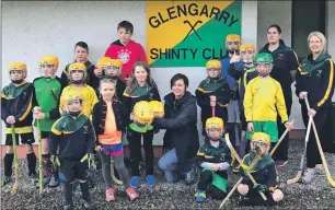  ??  ?? Debi Mackenzie of Cruise Loch Ness, centre, with members of Glengarry junior shinty team and their coaches.