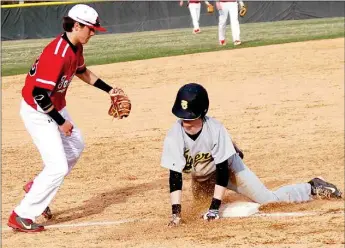  ?? BEN MADRID ENTERPRISE-LEADER ?? Prairie Grove’s Isaac Disney slides in front of Farmington’s Drew Vinson. The Tigers defeated the Cardinals, 11-4, on March 16 in a non-conference baseball contest hosted by Farmington.