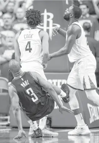  ?? Brett Coomer / Houston Chronicle ?? Guard Chris Paul hits the deck after taking a shot over two Warriors and suffering a strained hamstring for his trouble. Paul will miss Game 6 with the Rockets up 3-2 in the series.