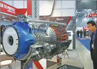  ?? BLOOMBERG ?? A visitor looks at a model of a Honeywell Aerospace T55 engine at an internatio­nal aerospace and defense exhibition in Goyang, South Korea.