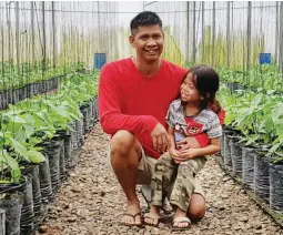  ??  ?? FUTURE AGRICULTUR­IST – Michael Batayola considers his three-year-old son John Matthew his future agricultur­ist. That is why he always brings with him to farms that consult him regarding synthetic pesticide-free farming of food crops. Here, father and...