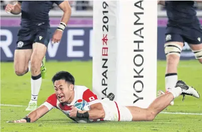  ??  ?? LEFT
Japan’s Kenki Fukuoka scores a try against Scotland.