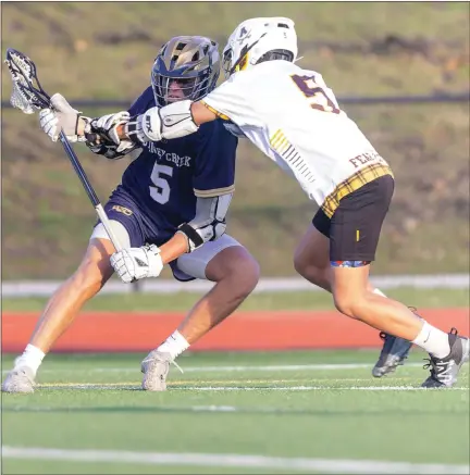  ?? TIMOTHY ARRICK — FOR MEDIANEWS GROUP ?? Rochester Adams’ Jace Morgan attempts to separate Stoney Creek’s Jonah McKay from the ball in the Cougars’ 8-2victory on Thursday in Rochester Hills.