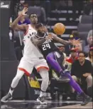  ?? The Associated Press ?? Sacramento Kings forward JaKarr Sampson, right, loses the ball as he goes to the basket against Toronto Raptors forward Pascal Siakam during first-half NBA action on Sunday in Sacramento, Calif.