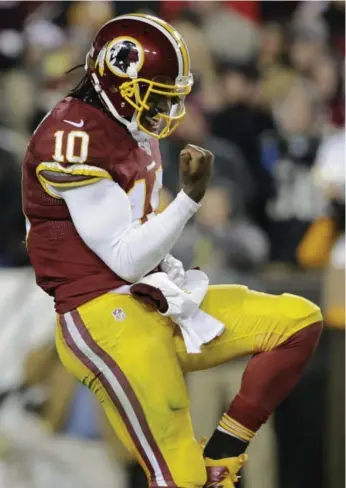  ?? MARK TENALLY/THE ASSOCIATED PRESS ?? Redskins quarterbac­k Robert Griffin III celebrates a second-half touchdown against the Eagles on Saturday.