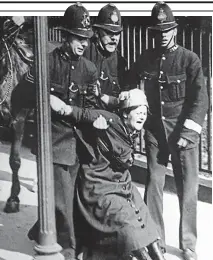  ??  ?? Fighting for a cause: Three bobbies arrest a suffragett­e outside Buckingham Palace in 1914