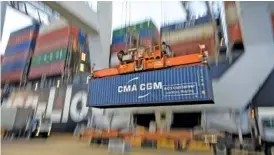  ?? AP PHOTO/STEPHEN B. MORTON ?? A ship-to-shore crane lifts a container in 2018 at the Port of Savannah in Savannah, Ga.