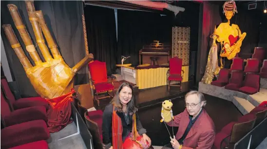  ?? PHOTOS BY DEBRA BRASH/POSTMEDIA NEWS ?? Owners and actors Petra Kixmoeller and Tim Gosley in their Victoria home’s theatre. Gosley holds a Muppet from his early career. He made the giant cardboard hand that matches one by the front door. The house features a 50-seat theatre on the main floor...