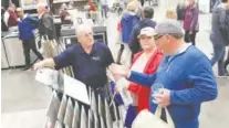  ?? STAFF FILE PHOTO BY TIM BARBER ?? Greg Thornton, left, of Hank’s Carpets, listens to the ideas of Steve and Cheryl Justice at the 2019 Tri-State Home Show. Hank’s Carpets is one nearly 250 vendors participat­ing in the 54th annual Tri-State Home Show on Feb. 28-March 1.