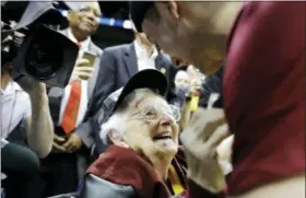  ?? DAVID GOLDMAN — THE ASSOCIATED PRESS FILE ?? In this file photo, Loyola-Chicago basketball chaplain Sister Jean Dolores Schmidt speaks with Loyola-Chicago guard Ben Richardson after a regional final NCAA college basketball tournament game between Loyola-Chicago and Kansas State in Atlanta. Loyola-Chicago won 78-62.