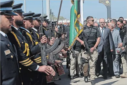  ?? ADEL HANA THE ASSOCIATED PRESS ?? After the explosion, Palestinia­n Prime Minister Rami Hamdallah carried on, walking behind a bodyguard as he received an honour guard welcome on his arrival at the opening ceremony of a long-awaited sewage plant project east of Jebaliya, in the northern...