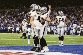  ?? Zach Bolinger / Associated Press ?? Raiders quarterbac­k Derek Carr (4) and wide receiver Hunter Renfrow (13) celebrate a touchdown against the Colts. Las Vegas won the game on a late field goal.