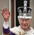  ?? Oli Scharf/AFP via Getty Images ?? Britain's King Charles III wears the Imperial state crown and waves from the Buckingham Palace balcony on May 6, 2023, after his coronation.