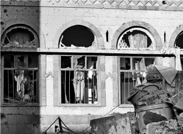  ?? REUTERS ?? A boy looks from the window of his damaged house at the site of an air strike in Sanaa, Yemen