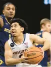  ?? MIKE KROPF/AP ?? Virginia’s Kihei Clark drives to the basket against Notre Dame on Saturday. Clark broke John Crotty’s school record for career assists.