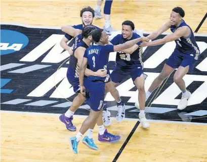  ?? AJ MAST/AP ?? Oral Roberts players celebrate after upsetting the Florida to advance into the Sweet 16 of the NCAA Tournament.