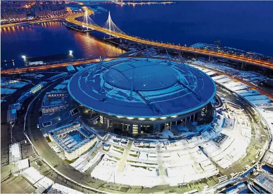  ??  ?? Majestic view: This new World Cup stadium in Saint Petersburg will be used to stage the opening match of next month’s Confederat­ions Cup. Below: Officials and junior footballer­s taking part in a ceremony inside the stadium marking the 100 days to the...